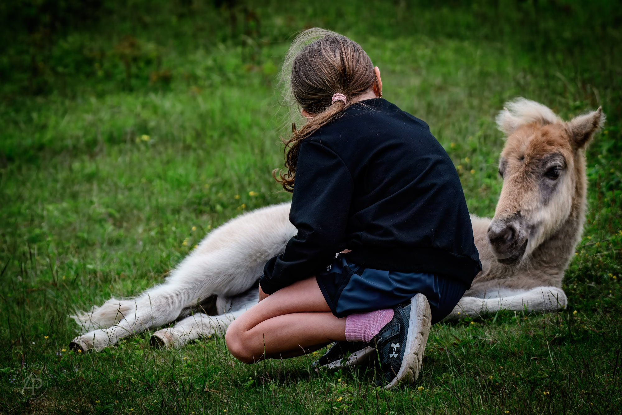 Girl sitting with foal Grayson Highlands